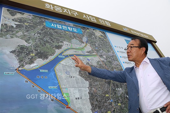 지난 18일 오전 8시에 화옹방조제 위에 올랐다...우정읍 이장단협의회 김국진(61, 호곡리 이장) 회장이 화홍지구 간척사업에 대한 설명을 하고 있다.ⓒ경기타임스